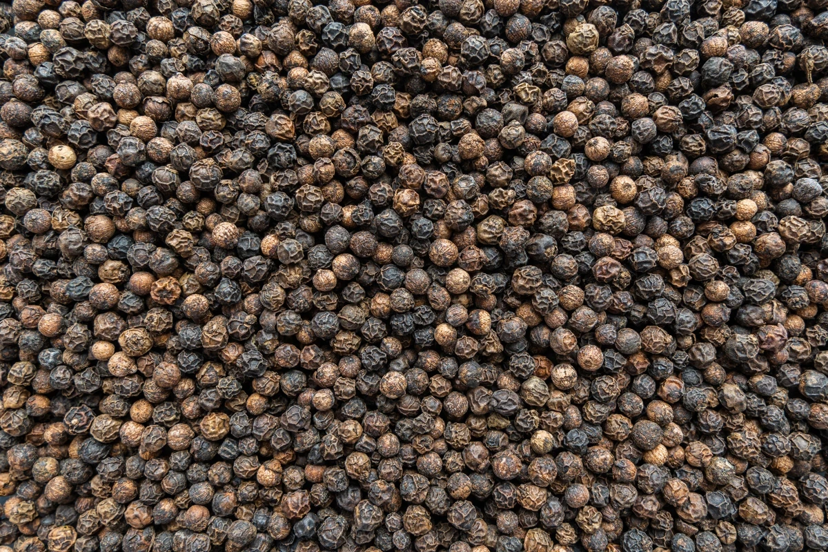 Dark whole peppercorns pictured in the catalogue's Black and White Pepper entry